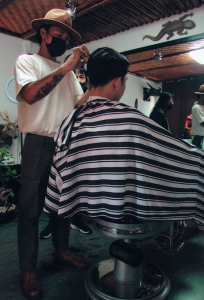 guy sitting getting a haircut