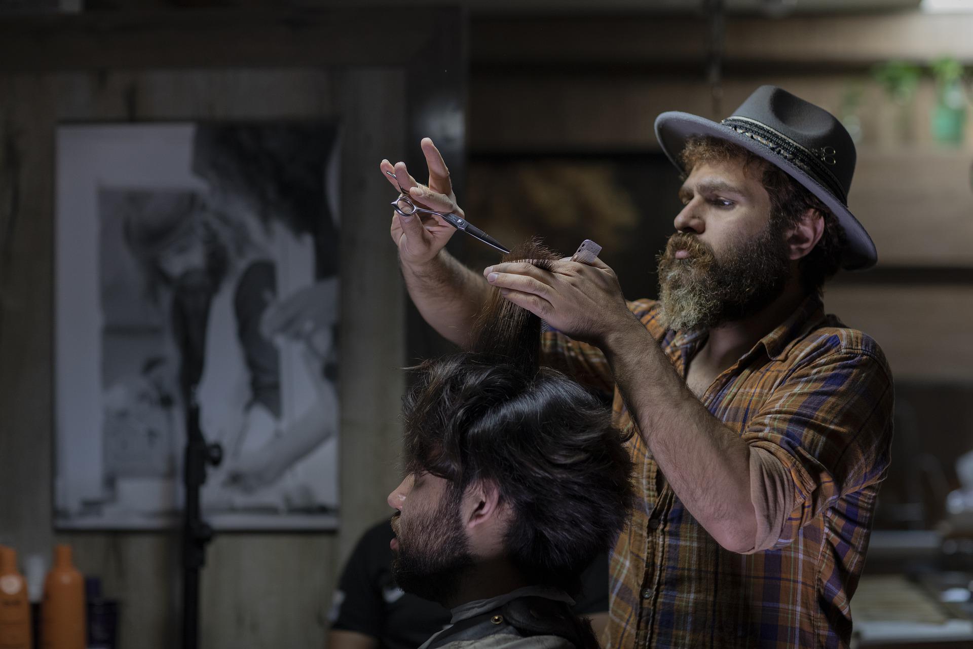 stylish barber giving a scissor cut