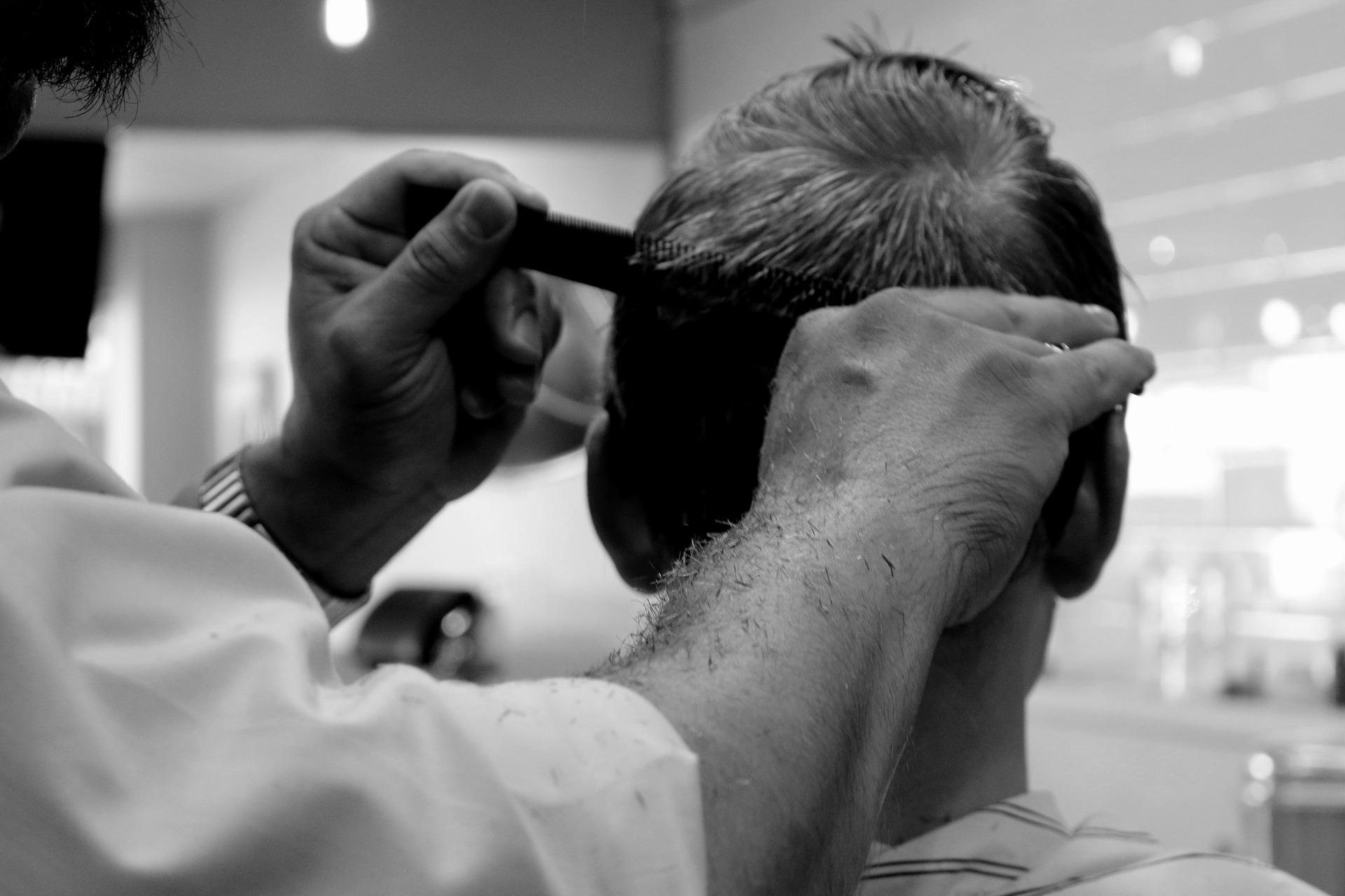 man using comb to brush hair